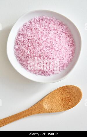 Bath salt in bowl and wooden spoon Stock Photo
