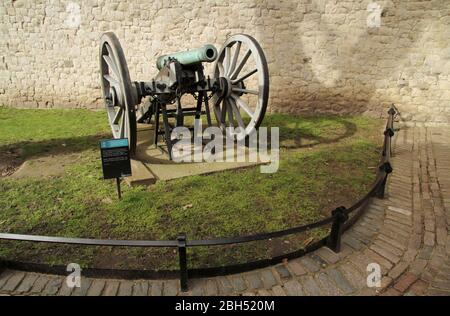 An historic artillery piece sits in front of the walls of the Tower of London March 13, 2020 in London, England Stock Photo