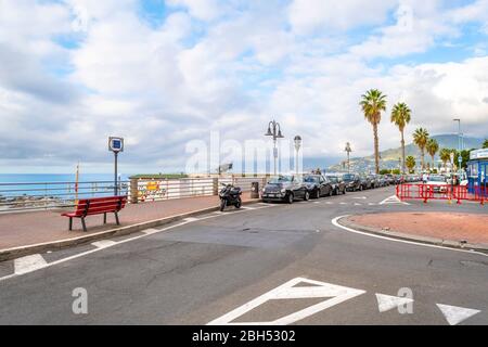 The main coastal road along the Mediterranean sea and beach through the town of Ventimiglia, Italy, in the Imperia region of the Italian Riviera Stock Photo