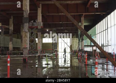 A worker walks through the gutted and empty interior of the old Canada Post building on Georgia Street in downtown Vancouver, British Columbia. The re Stock Photo