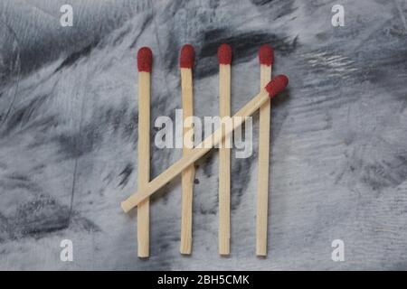 Five matchsticks create tally marks. Stock Photo