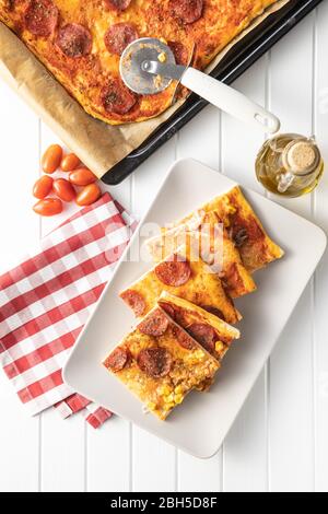 Pieces of homemade Italian pizza on plate. Top view. Stock Photo