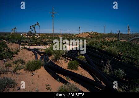 Eddy County, New Mexico, USA. 23rd Apr, 2020. Oil lines stretch along a road within the Permian Basin oil fields in Eddy County, New Mexico. Credit: Joel Angel Juarez/ZUMA Wire/Alamy Live News Stock Photo