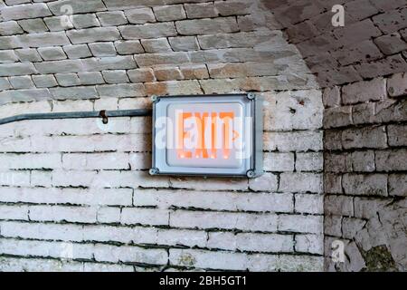 Exit sign on old brick wall good for backdrop or vintage photography background Stock Photo