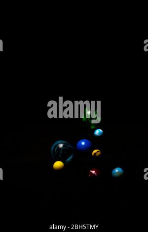 marbles on black background, ideal for children's games Stock Photo