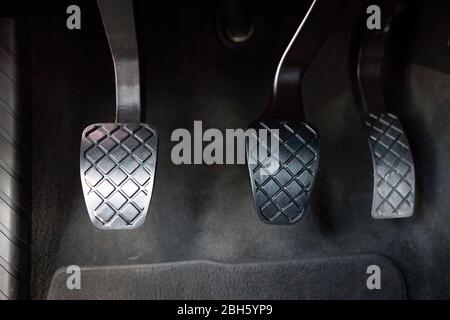 Modern luxury car interior element metal gas clutch and brake pedal. Sport  car with metal manual gearbox controls Stock Photo - Alamy