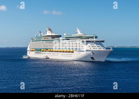 George Town, Grand Cayman Island, UK - April 24, 2019: Cruise Ship Adventure of the Seas is anchored in front of the George Town city in the tropical Stock Photo