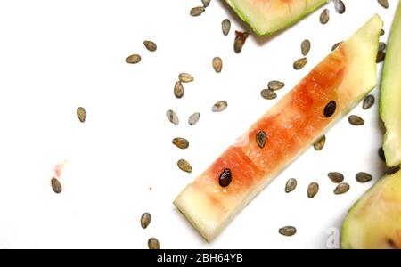 eaten slice of watermelon with watermelon seeds isolated on white backgrounds Stock Photo