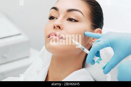 lifting arrows on a female face showing the effect of skin rejuvenation and wrinkle smoothing Stock Photo