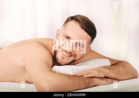 Handsome man relaxing in spa ,Closeup of a positive and smiling man at wellness resort Stock Photo