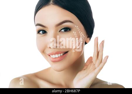 portrait of asian woman with perfect skin of the face, with arrows on face, concept of lifting skin. Cosmetology, elastic and young skin of the face. Stock Photo
