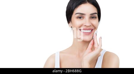 beautiful woman using cotton pad. cleaning her skin by cotton pad isolated on white. make-up remover Stock Photo