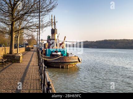 BIDEFORD, NORTH DEVON, ENGLAND, UK - MARCH 28 2020: Old boat, maybe tug, moored on the quay in this small, historic harbour town. Spring sunshine. Stock Photo