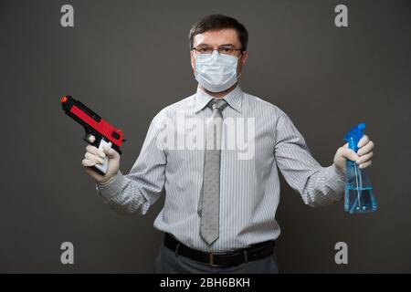 Attractive young man posing in futuristic detective outfit, holding a  handgun Stock Photo - Alamy