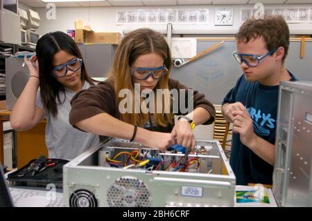 Austin, Texas USA, February  10, 2005: High school students at Texas School for the Deaf work together doing hands-on installation of computer components. during computing repair class.  ©Bob Daemmrich Stock Photo