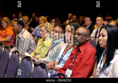 San Antonio, Texas USA, May 2006:  Ethnically mixed group of attendees at annual convention of trade association listen to speaker in packed meeting hall in convention center. ©Bob Daemmrich Stock Photo