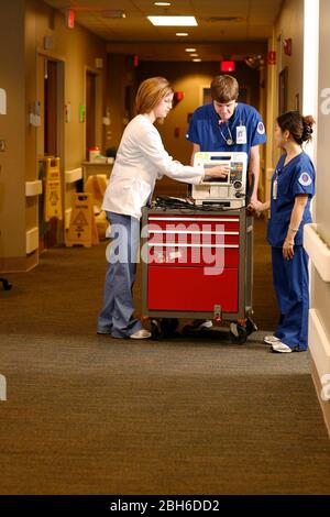 Waco, Texas USA, March 12, 2009: Nursing instructor Kacie Spencer, MSN, RN, of McClennan Community College with some of her students (in blue) who obtain practical experience interning at a local hospital. ©Bob Daemmrich Stock Photo