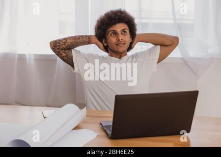 man architect , leaning Back On Chair while sitting at his working place in officeTime relax, after work done. Stock Photo