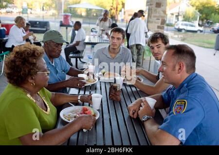 Austin, Texas USA, October 7, 2008. Residents greet public officials and police officers at the annual National Night Out neighborhood event where neighbors get together to help fight crime. This is the Chestnut Neighborhood Association meeting in east Austin that has a eclectic mix of long-time African-American residents and newcomers.   ©Bob Daemmrich Stock Photo