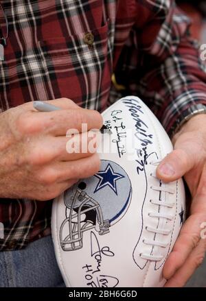 Austin, Texas USA, November 21, 2008: Legendary Dallas Cowboy defensive tackle Bob Lilly uses a Sharpie pen to autograph a commemorative football at a book signing for his new book, 'A Cowboy's Life.' Lilly's 14-year NFL career from 1961 to 1974 was highlighted by seven All-Pro selections and one Super Bowl victory in 1972.  ©Bob Daemmrich Stock Photo