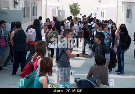 El Paso, Texas  May 28, 2009: Exterior views between classes outside the portable buildings at Mission Early College High School in the Soccoro school district of El Paso.  Bright Hispanic students can earn an associate degree at El Paso Community College while studying for their high school diploma in the program.  ©Bob Daemmrich Stock Photo