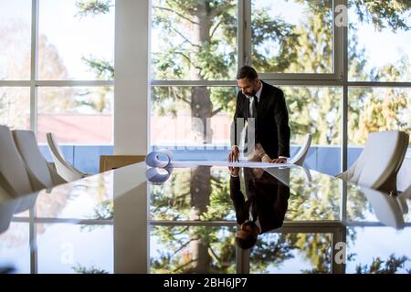 Handsome architect checking plans and blueprints in the office Stock Photo
