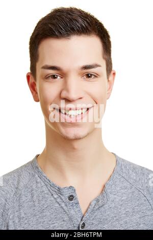 Laughing young man happily looks at the camera Stock Photo