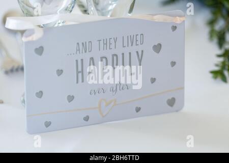 And they lived happily ever after white sign with love hearts wedding decoration Stock Photo