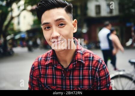 Portrait of young Vietnamese man in the city Stock Photo