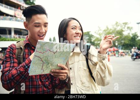 Asian couple using paper map on the street Stock Photo
