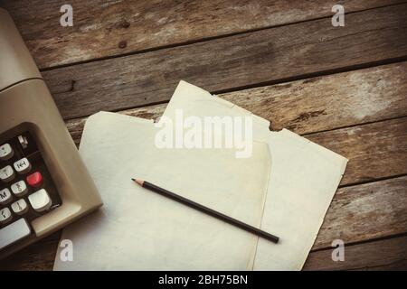 Typewriter, pensil and paper on wooden background. Literature, author and writer, creative writing workshop and journalism concept.