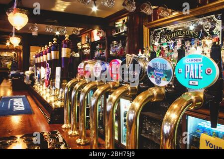 Oxford, UK - 02 March 2020: Rows of draught beer in a typical British pub Stock Photo