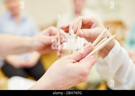 Seniors choosing crayons in painting therapy in retirement home Stock Photo