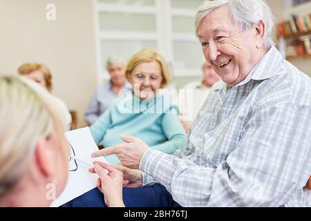 Senior man receives health advice from a doctor in a nursing home Stock Photo