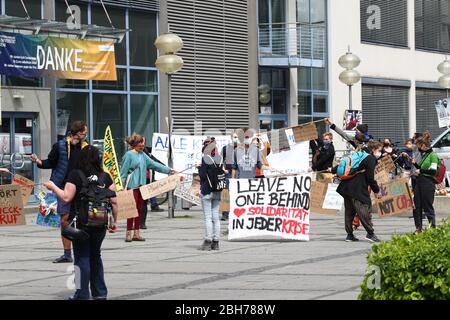 Jena, Germany. 24th Apr, 2020. Participants of a demonstration stand on ...