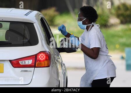 Number plate pixelated by PA picture desk. A medic takes a swab from a key worker at a drive-through testing station at Chessington World of Adventures in Surrey, as the UK continues in lockdown to help curb the spread of the coronavirus. Stock Photo