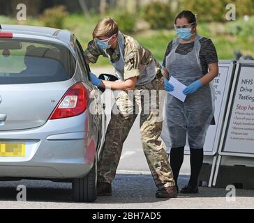 Number plate pixelated by PA picture desk. A soldier takes a swab from a key worker at a drive-through testing station at Chessington World of Adventures in Surrey, as the UK continues in lockdown to help curb the spread of the coronavirus. Stock Photo