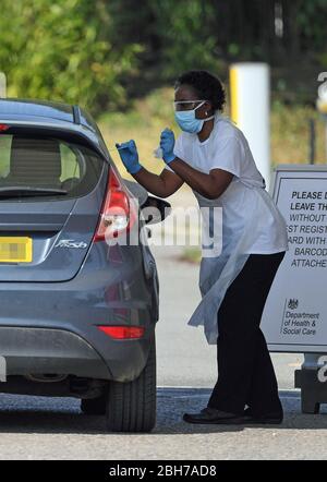 Number plate pixelated by PA picture desk. A medic takes a swab from a key worker at a drive-through testing station at Chessington World of Adventures in Surrey, as the UK continues in lockdown to help curb the spread of the coronavirus. Stock Photo