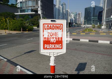 Dubai UAE December 2019 Red and white sign for no parking in the loading zone outside a building. Residential and commercial area with No Parking, Loa Stock Photo