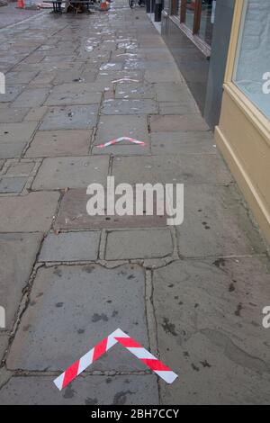 social distancing arrows on city pavement due to coronavirus lockdown, England, March 2020 Stock Photo