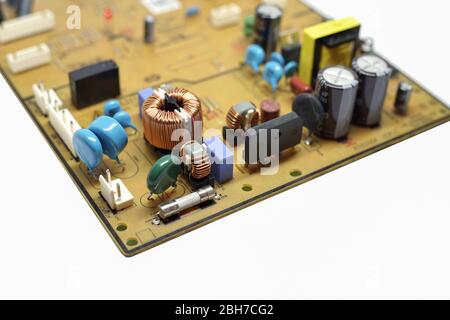 Closed up shot capacitor, coil, IC and Electronics parts on circuit board. Stock Photo