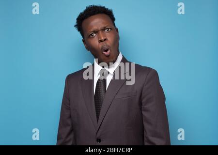 Amazement african american businessman looking at camera with shocked face Stock Photo