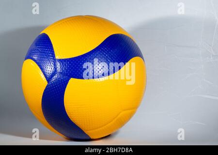 Blue and yellow ball for playing volleyball on the white background Stock Photo