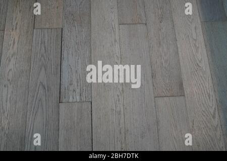 Detailed Natural Wooden Texture or Background. Floor tile with grain across in gray and brown tones. Porcelain tile with imitation of multi-colored wo Stock Photo