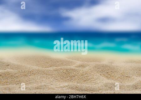 Background. Yellow sand on a blurred turquoise sea background. Cloudy sky Free space for any material. Stock Photo