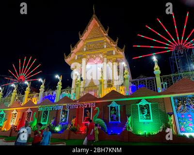 Photo of Night festival of Thai temple with colorful neon lamp on Makha Bucha Day Pranburi Thailand February 21, 2019