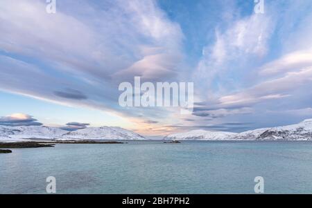 winterlandscape with dramatic sky on Kvaloeya Island near Tromsoe in northern Norway, landscape Stock Photo