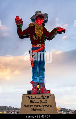 Neon figure of cowboy at sunset near casinos in West Wendover, Nevada, USA Stock Photo