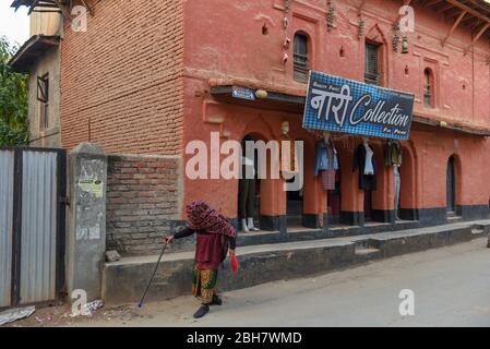 Tansen, Nepal - 14 January 2020: old woman in front of a shop at Tansen in Nepal Stock Photo