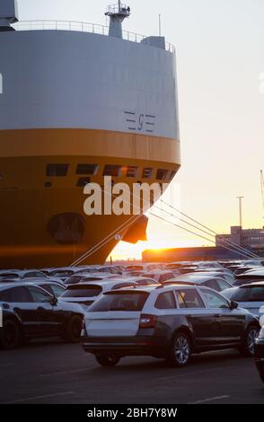 22.03.2020, Bremerhaven, Bremen, Germany - New cars are waiting for shipment on the BLG premises, in the picture carfeeder of the Grimaldi Lines shipp Stock Photo